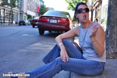 Brunette babe smoking while loitering on the street - N