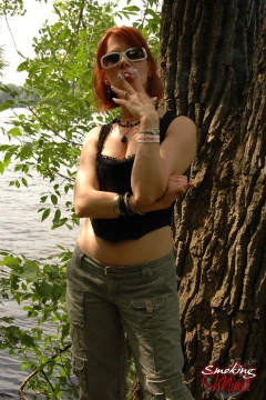 Busty babe smoking and posing sexy in the woods - N