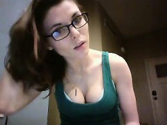 geeky-brunette-displays-her-delicious-cleavage-in-a-green-t